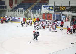 Hughes taking the time to help out at a hockey camp in Scotland. 